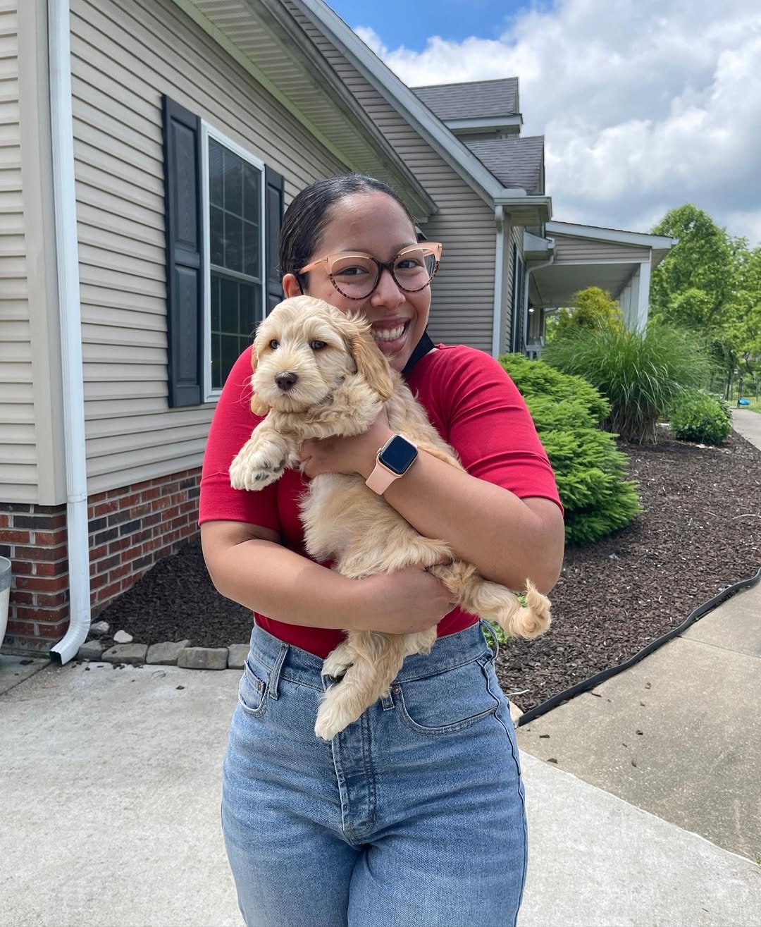 Sarah Jenkins with her Goldendoodle in the backyard